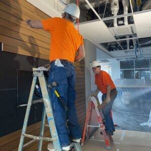 Finish carpenter installing interior trim and detailed woodwork