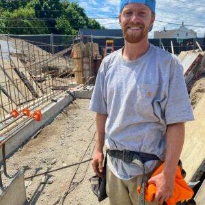 Concrete form carpenter preparing structural formwork on job site